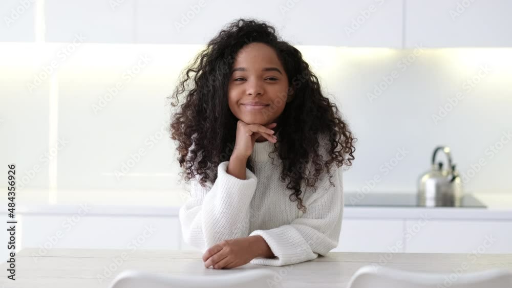 Portrait beautiful African American black girl at modern home Smiling young woman with curly hair looking at camera. Portrait beautiful African American black girl at modern home Smiling young woman with curly hair looking at camera.