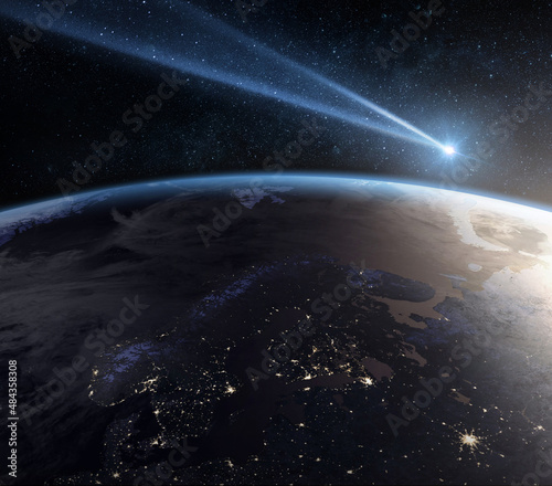 Comet, asteroid, meteorite flying to the planet Earth. Glowing asteroid and tail of a falling comet threatening the safety of the Earth. Elements of this image furnished by NASA.