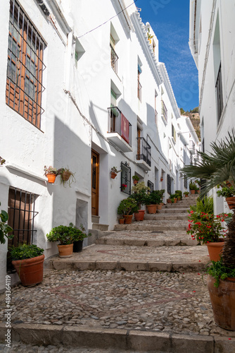 Fototapeta Naklejka Na Ścianę i Meble -  Streets of Frigiliana village. Beautiful white houses and small streets. Typically Andalusian town. Touristic travel destination on Costa del Sol. Vertical photography.   