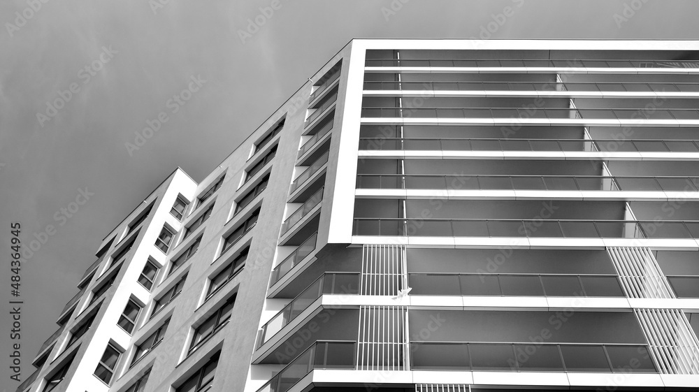Modern luxury residential flat. Modern apartment building on a sunny day. White apartment building with a blue sky. Facade of a modern apartment building. Black and white. Modern luxury residential flat. Modern apartment building on a sunny day. White apartment building with a blue sky. Facade of a modern apartment building. Black and white.