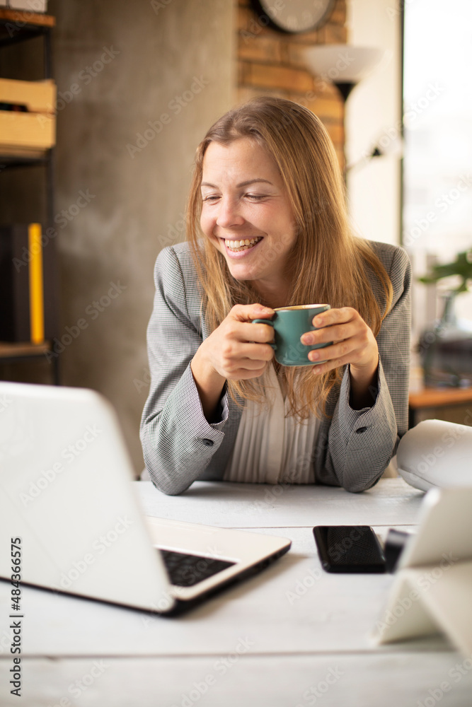 Happy businesswoman working on laptop. Portrait of beautiful businesswoman having video call. Happy businesswoman working on laptop. Portrait of beautiful businesswoman having video call.