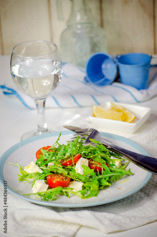 Arugula salad with feta cheese and cherry tomatoes Arugula salad with feta cheese and cherry tomatoes