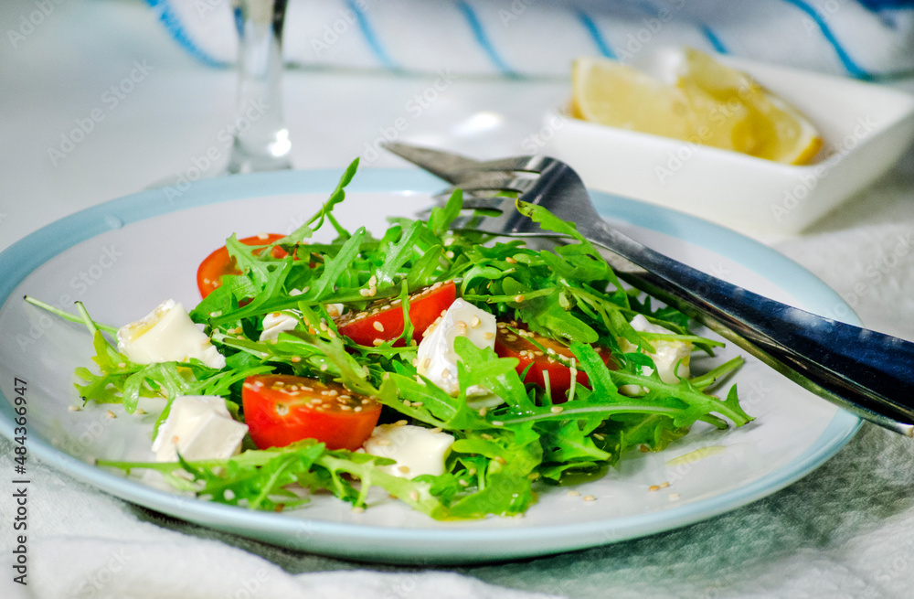 Arugula salad with feta cheese and cherry tomatoes