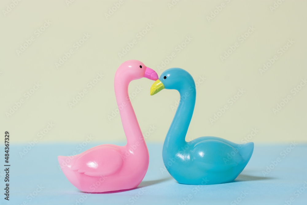Pink and blue swans on colored background Pink and blue swans on colored background