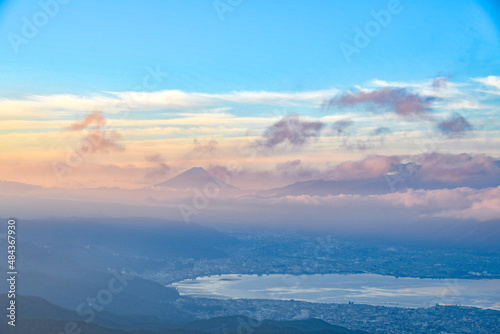 Mt. Fuji sit with Lake Suwako in the hazy and obscure morning light in summer Japan.