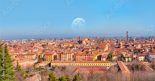 Panoramic view of red rooftops and buildings - Cityscape from above, view of Garisenda and Asinelli tower with full moon - Bologna, Italy "Elements of this image furnished by NASA"