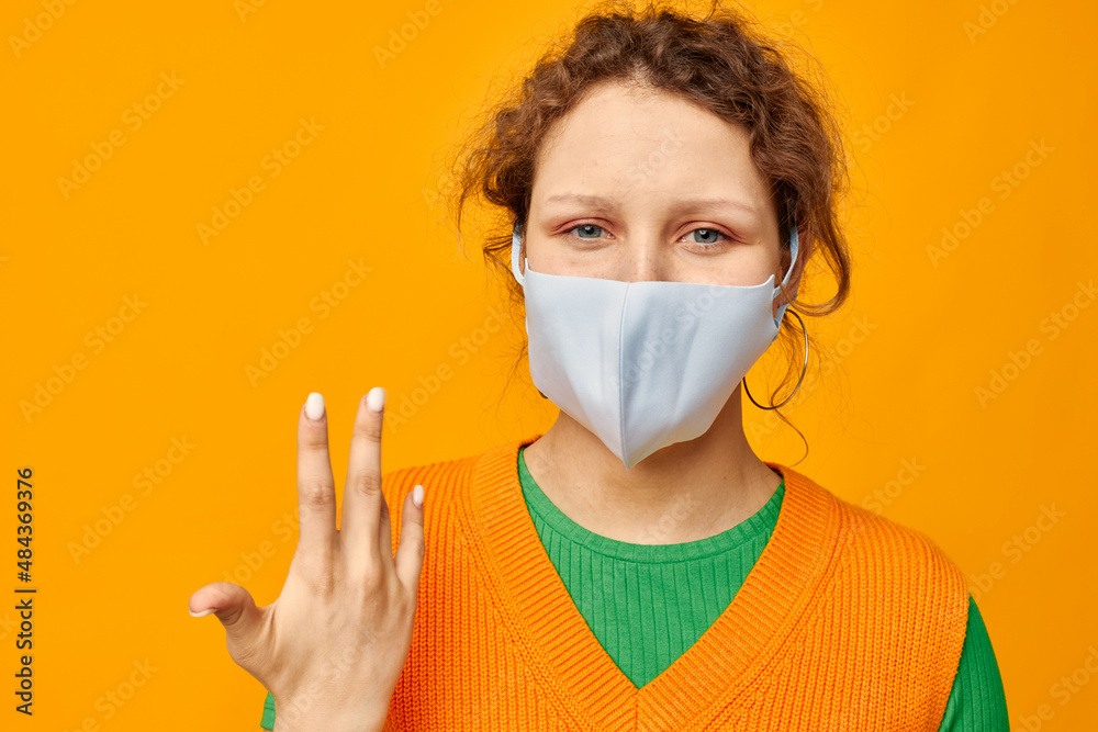 pretty girl in a yellow t-shirt medical mask protection cropped view unaltered pretty girl in a yellow t-shirt medical mask protection cropped view unaltered