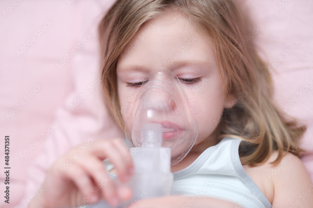 Little girl making inhalation of medicine for cough treatment Little girl making inhalation of medicine for cough treatment