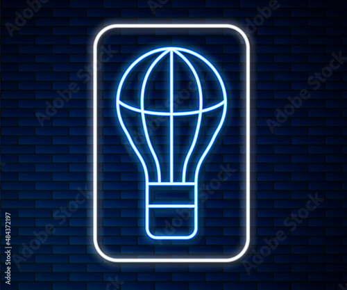 Glowing neon line Hot air balloon icon isolated on brick wall background. Air transport for travel. Vector