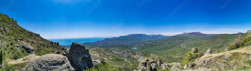 Ancient limestone high mountains of rounded shape in the air haze. The Valley of Ghosts. Demerji. Crimea