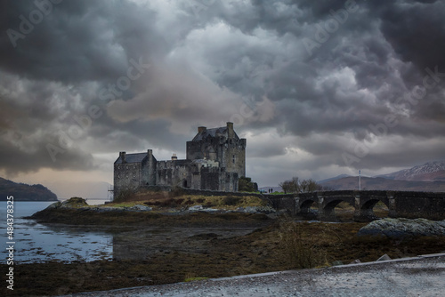 Scottish castle Eilean Donan situated in the Kyle of Lochash isolated against a stormy sky.
