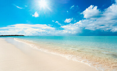Beautiful background image of tropical beach. Bright summer sun over ocean. Blue sky with light clouds, turquoise ocean with surf and clear white sand. Harmony of clean environment.