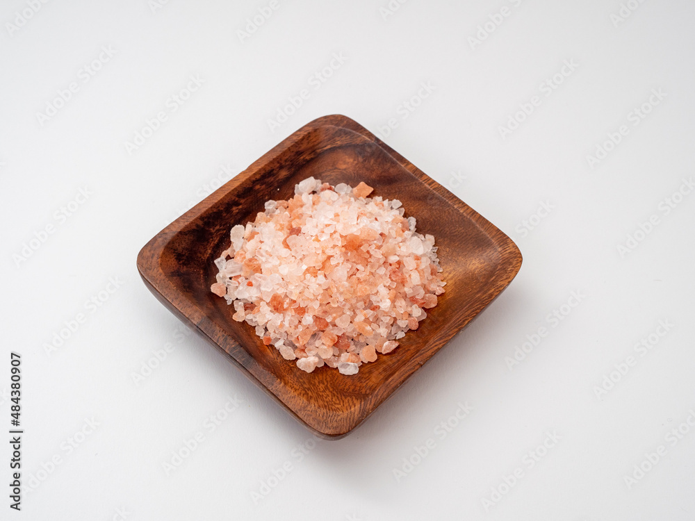 Pink salt on a white background.