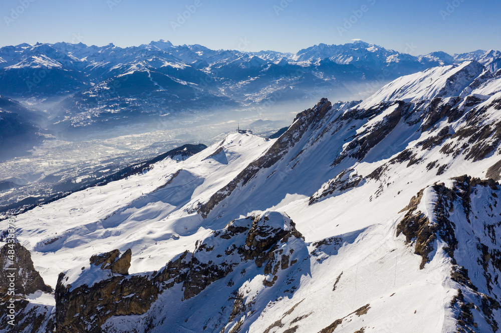 Dramatic aerial view of the alps mountain above the Anzere ski resort overlooking the Rhone valley and Sion in Valais in Switzerland.
