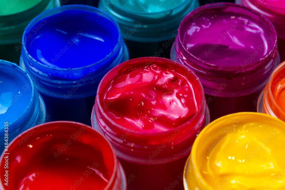Selective focus open jars with gouache of different colors close-up. Hobby - painting Selective focus open jars with gouache of different colors close-up. Hobby - painting