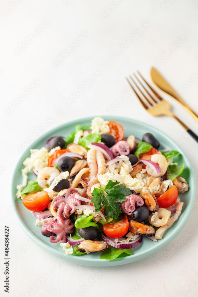 Seafood with vegetables in a plate on the table.