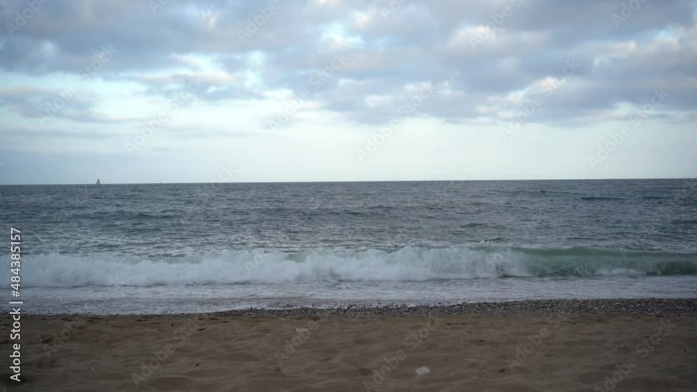 waves hitting the coast with cloudy sky waves hitting the coast with cloudy sky