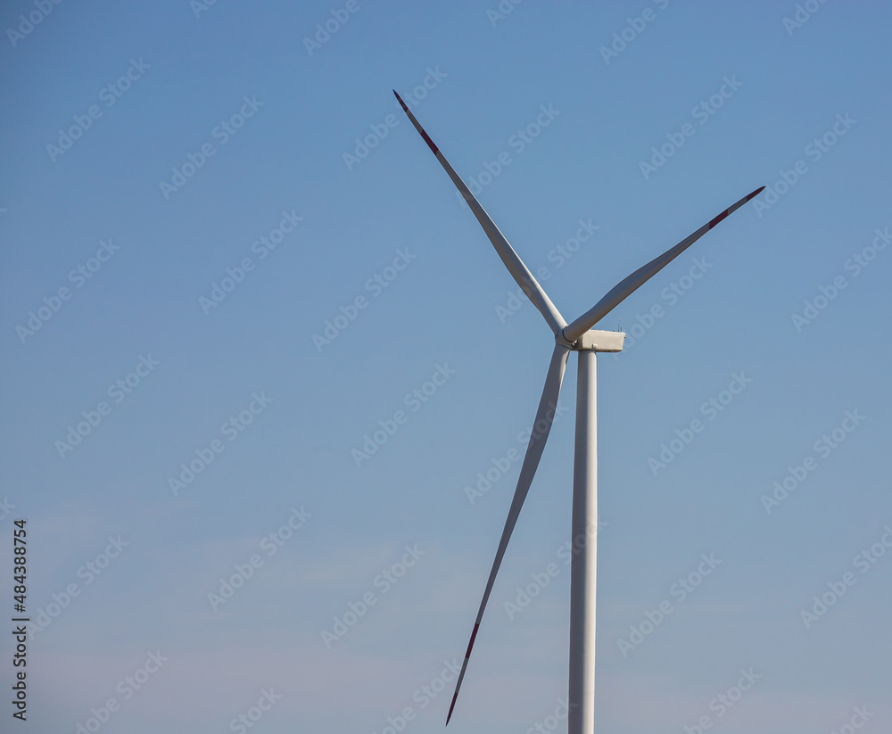 wind mill or also wind-turbine on wind farm in rotation to generate electricity energy on outdoor with sun and blue sky, conservation and sustainable energy concept wind mill or also wind-turbine on wind farm in rotation to generate electricity energy on outdoor with sun and blue sky, conservation and sustainable energy concept