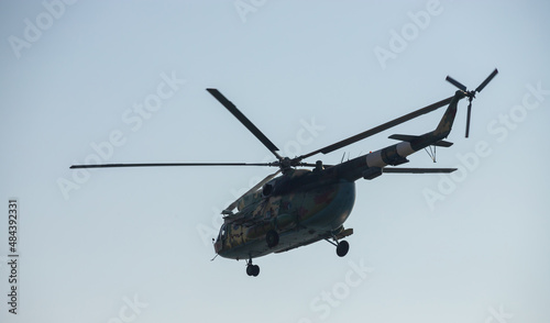 Fototapeta Naklejka Na Ścianę i Meble -  The military helicopter against the blue sky
