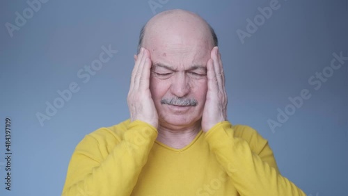 Senior hispanic adult man having terrible headache.