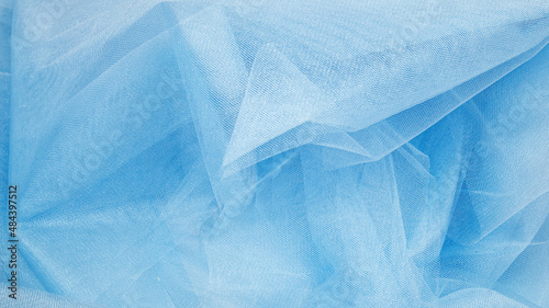Background crumpled tulle fabric beautiful pastel blue color. photo