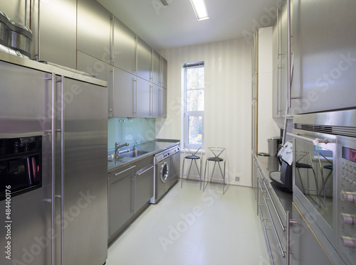 Modern interior of metal kitchen in luxury apartment. Home appliances.