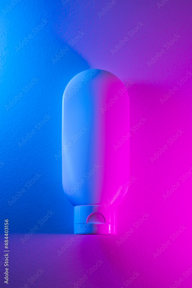 Plastic white tube for lotion with beautiful purple and pink color. Skincare sunscreen cosmetic in top view. Beauty concept for face body care Plastic white tube for lotion with beautiful purple and pink color. Skincare sunscreen cosmetic in top view. Beauty concept for face body care