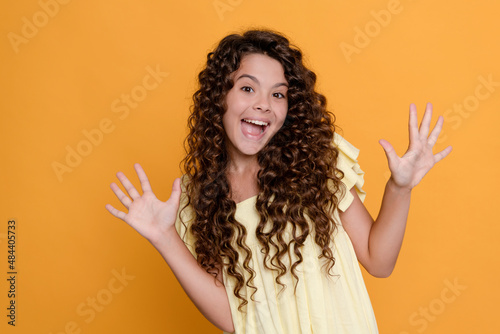 amazed child with long curly hair and perfect skin, portrait