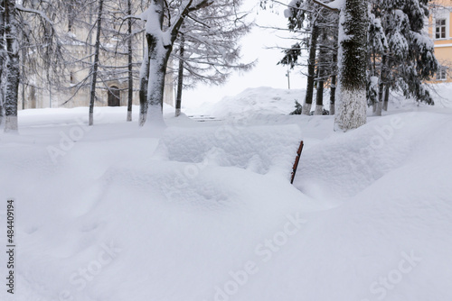 Snow covered bench in the city park © orininskaya