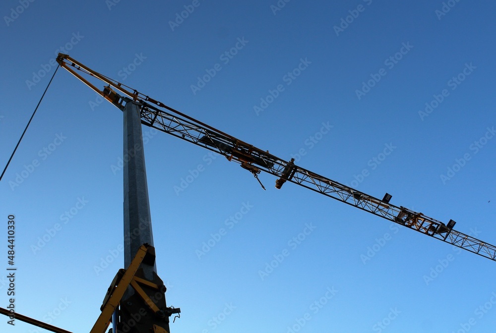 evocative image of the silhouette of a crane on a construction site at dusk
evocative image of the silhouette of a crane on a construction site at dusk