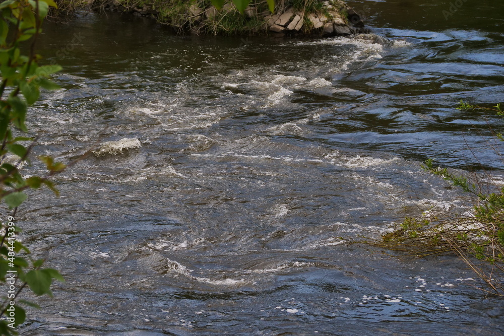Swirling and bubbling water in a fast flowing river ruhr in germay with strong currents. Swimming in it is dangerous Swirling and bubbling water in a fast flowing river ruhr in germay with strong currents. Swimming in it is dangerous
