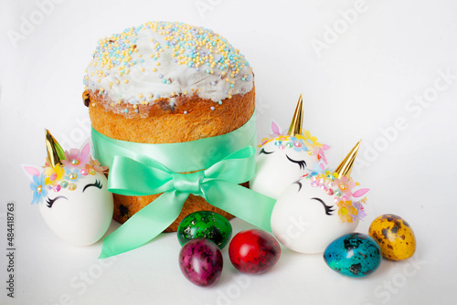 spring holiday. Easter cake and colorful brightly colored quail eggs and three white unicorn eggs