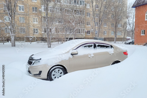 A car piled up with snow city center.