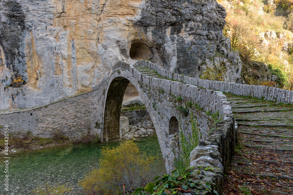 Kokori's old arch stone bridge (Noutsos) during fall season situated on the river of Voidomatis in Zagori, Epirus Greece.