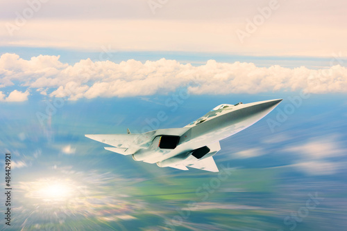 Fighter jet plane in flight motion blur, military aircraft, army airplane flying in sky with clouds, front top view.