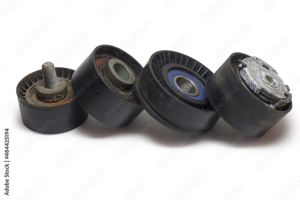 tensioner, idlers, pulleys of car actuators of engine and alternator. dismantled rollers of car drive mechanisms. stacked in neat line, isolated on white background, with clipping path tensioner, idlers, pulleys of car actuators of engine and alternator. dismantled rollers of car drive mechanisms. stacked in neat line, isolated on white background, with clipping path
