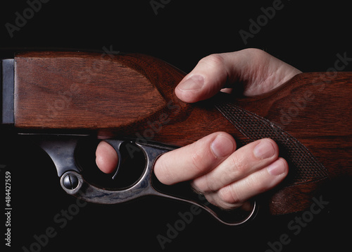 Bilde på lerret Lever-action hunting rifle detail with finger squeezing trigger