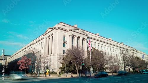 The United States Department of Justice Robert F. Kennedy Building is seen on a winter day from Constitution Avenue NW in downtown Washington, DC. The time-lapse wide shot pans from left to right. photo