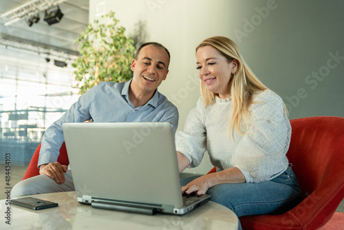 a business couple working together in the office, checking the company's data on the laptop