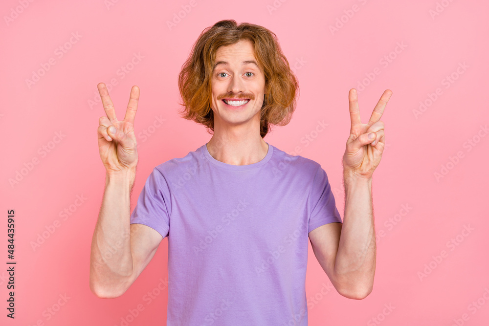 Portrait of attractive cheerful glad guy showing double v-sign good mood isolated over pink pastel color background Portrait of attractive cheerful glad guy showing double v-sign good mood isolated over pink pastel color background