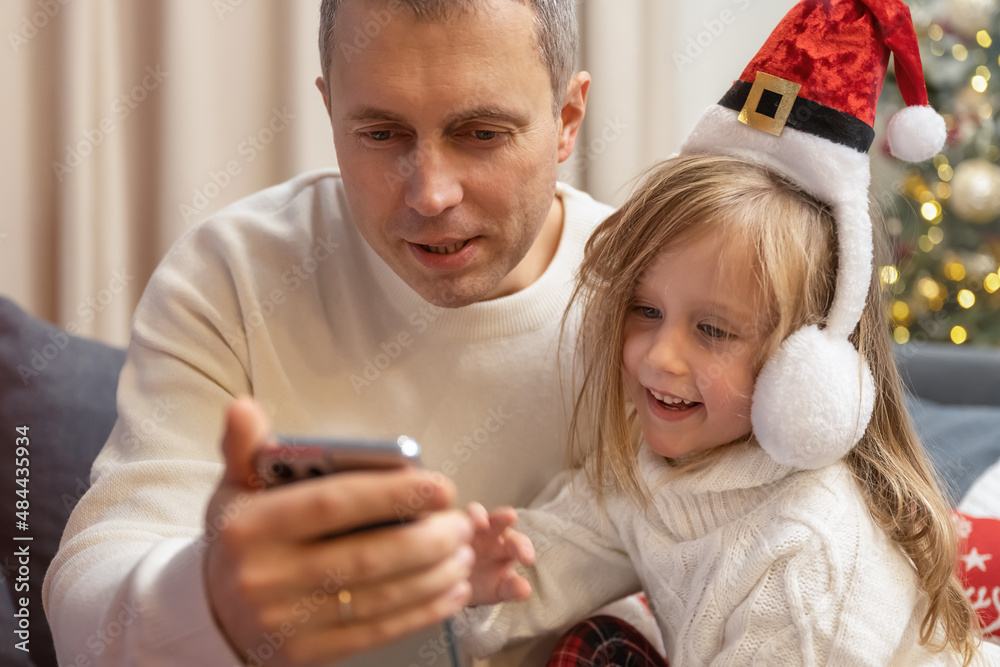 father and daughter talking on video call father and daughter talking on video call