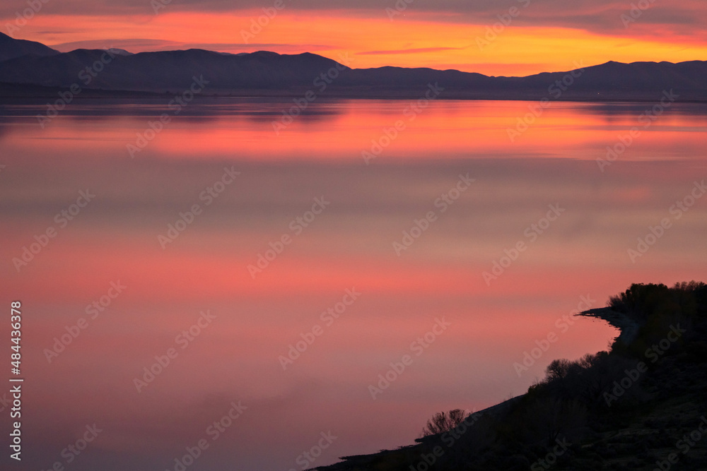 Colorful hues reflecting in lake during sunset in Utah