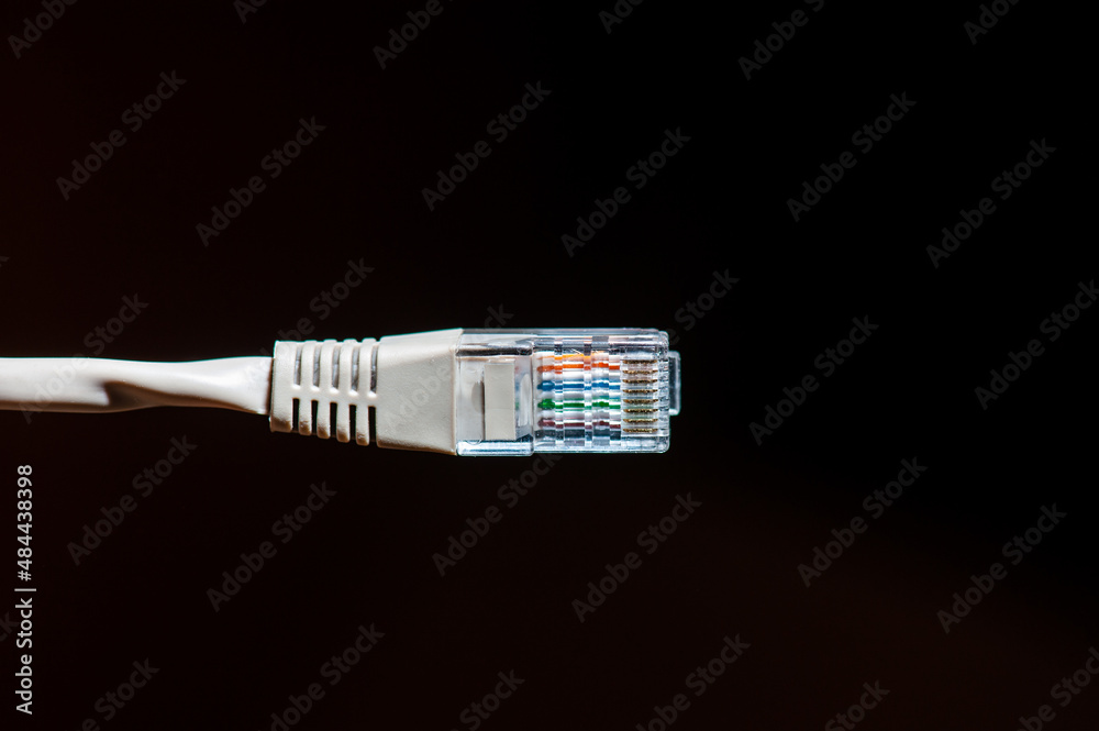 Wired internet cable connection on black background Wired internet cable connection on black background