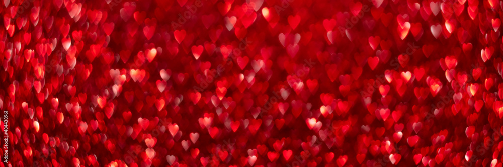 Red hearts, sparkling glitter bokeh background texture. Holiday valentines day lights. Abstract defocused header. Wide screen wallpaper. Panoramic web banner with copy space for design