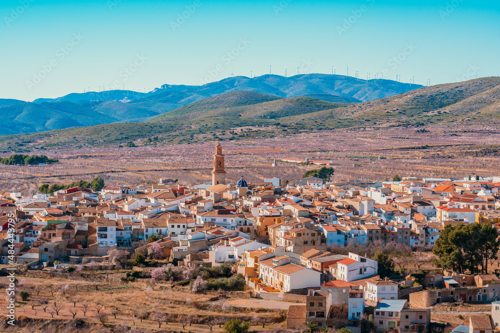 Springtime, almond trees blossom in a picturesque village in Spain. Panoramic view of Alcublas, Valencia.