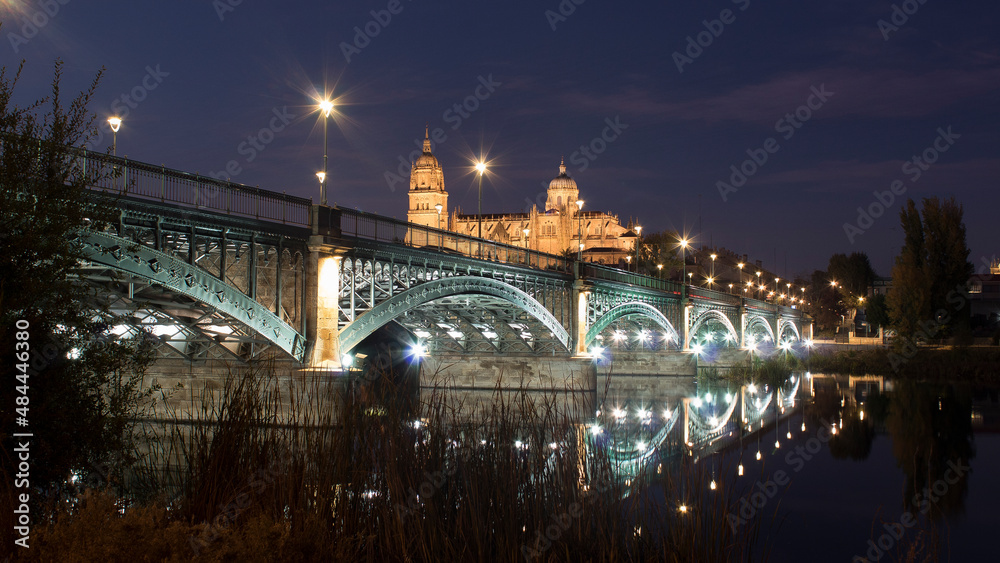 Salamanca Cathedral at night with reflections in the river
