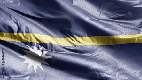 Nauru textile flag waving on the wind loop. Naursky banner swaying on the breeze. Fabric textile tissue. Full filling background. 10 seconds loop. photo