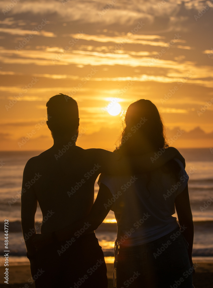 couple watching the sunrise at the beach