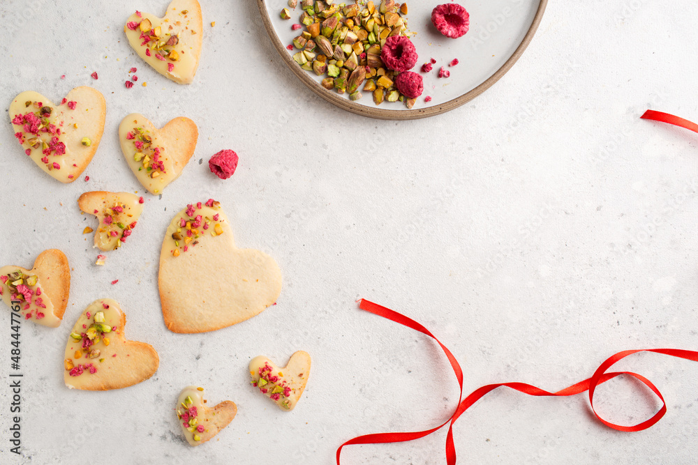 Cookie hearts with raspberries. Background for Valentine's Day. Nut cookies. Baking for lovers.	
