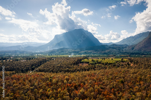 Aerial view of Doi Luang Chiang Dao mountain with autumn colorful forest in national park on bright day